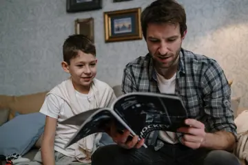 Man And Child Reading