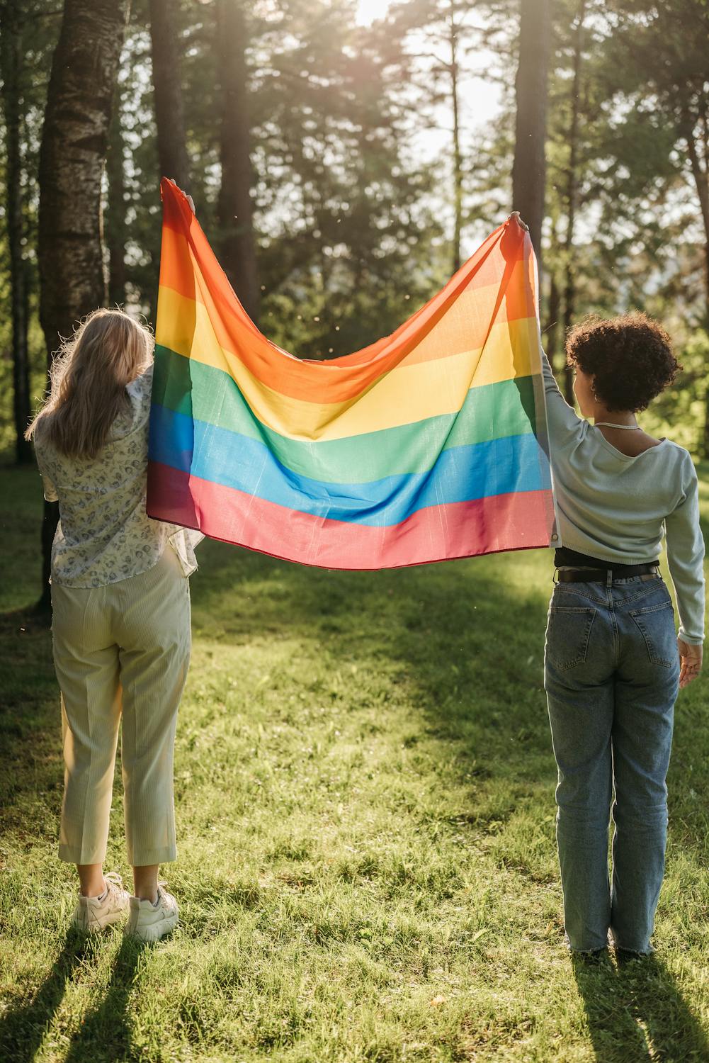 Women Holding Rainbow Flad