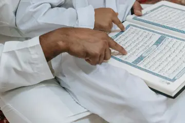 Boy And Man Reading Quran