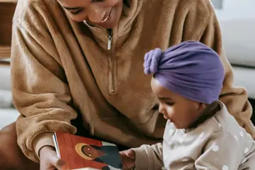 Woman And Baby Reading