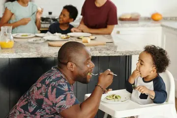 Man And Baby In Highchair