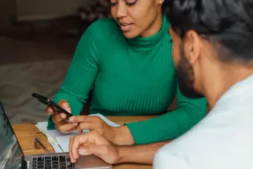 Couple On Phone And Laptop